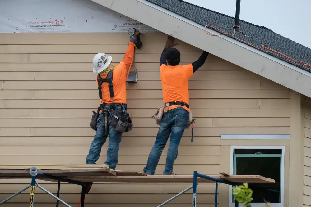 Professional siding installation team at work
